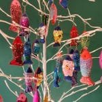 Colourful sequinned fish keyrings hanging from artificial tree - pic 3