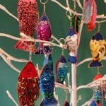 Colourful sequinned fish keyrings hanging from artificial tree - pic 2